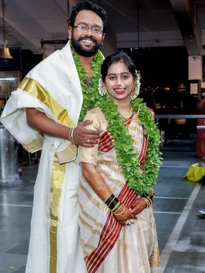 Another shot of the lovely couple. The full view shows how the Kerala style drape creates a clean and elegant line, perfect for a serene temple wedding.