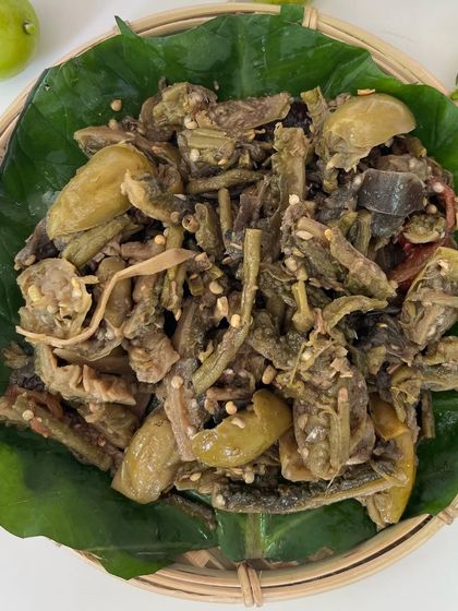 'Rusep', a traditional wild vegetable delicacy from the Ao tribe. It's a boiled mix of bitter eggplant, bitter gourd, and other local veggies, offering a unique bitter and tangy taste.