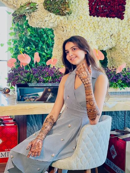 A posed shot of the client at a beautiful venue, her mehandi adding to her elegance.