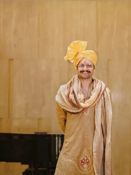 A relaxed and happy portrait of the groom. The soft lighting and his genuine smile reflect the joy and excitement of the wedding day.