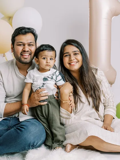 A happy family portrait from an at-home first birthday session. Celebrating this milestone together is what makes these photos so special.