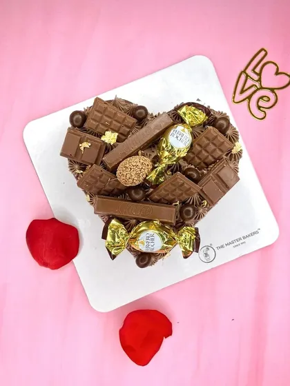 A heart-shaped pinata cake loaded with an assortment of chocolates like KitKat and Ferrero Rocher. It's a fun and indulgent way to celebrate Chocolate Day.