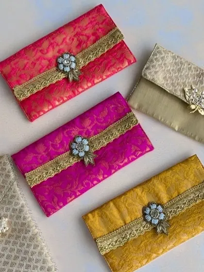 I offer a wide variety of shagun envelopes to suit any style. This collection shows different brocade fabrics and ornate embellishments, ensuring your gift is dressed to impress.