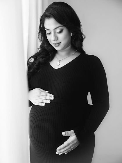 A quiet moment of connection with her baby. This black and white photo feels incredibly peaceful and intimate, capturing the inner world of the mother-to-be.