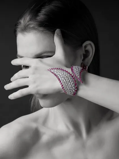 A dramatic, artistic pose to showcase this incredible ruby and diamond hand-cuff from Yoube Jewellery. The black and white photo with the pop of red creates a powerful, high-fashion statement.