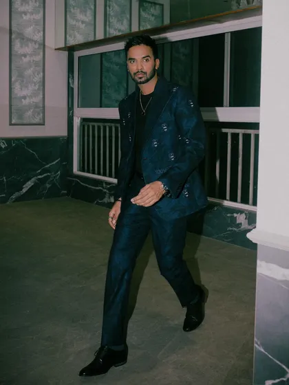Shakti Yadav wears our dark blue suit effortlessly, showcasing the signature SGM logo motif embroidered on a matte-finished wool jacket.