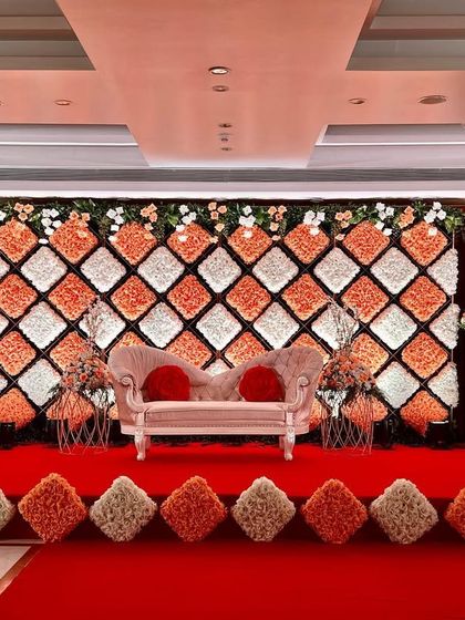 A wider view of the floral cushion wall, showing the grand scale and the way it commands the room with its vibrant colors and pattern.