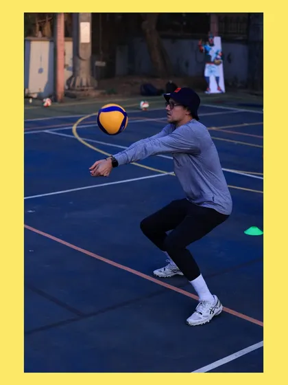 I demonstrate the low, ready stance for receiving a serve. Leading by example is a core part of my coaching philosophy.