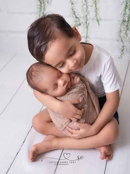 A big brother's protective and loving embrace. You can already see the strong bond forming between these two brothers.