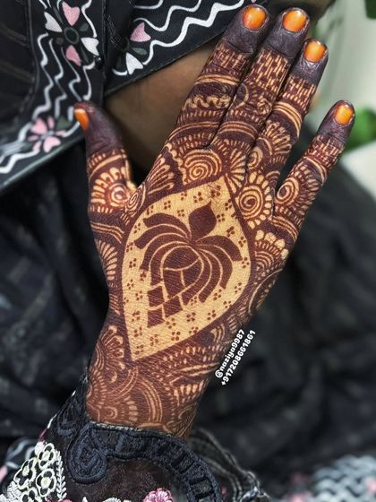 A close-up of the lotus design on a single hand. The use of negative space inside the lotus makes the pattern very striking.