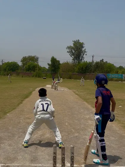 A view from behind the stumps as the bowler runs in.