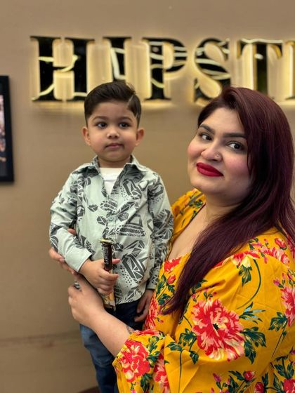A happy mom with her son, who is sporting a fresh and stylish new haircut.