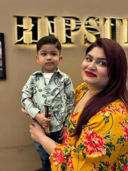 A happy mom with her son, who is sporting a fresh and stylish new haircut.