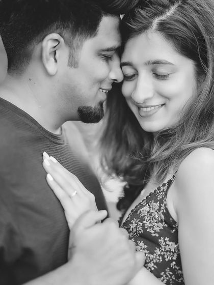 Another tender moment from their session, this black and white engagement photo showcases their gentle interaction and the detail of her ring.