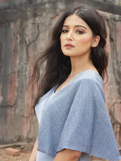 This powder blue jumpsuit with pleated cape sleeves is a perfect example of modern, elegant design. It's a sophisticated choice for a formal event or a designer showcase.