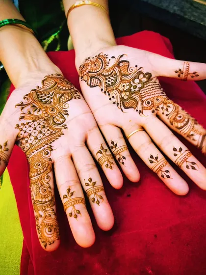 A pair of simple party designs. The asymmetrical patterns on each hand are a fun and modern take on festive mehendi.