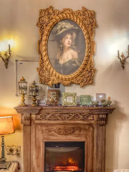 The fireplace is the heart of the cafe, and the vintage-style portrait above it adds to the old-world charm. It’s a perfect backdrop for a cozy conversation, especially on a rainy day.