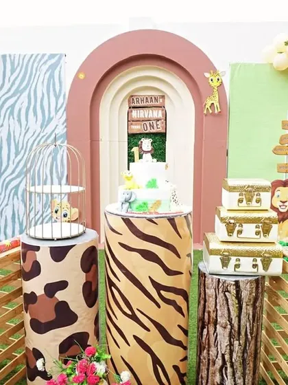 I love how this 'Wild One' safari theme came together for a first birthday. We used multiple themed backdrops, animal print plinths, and fun props like the jeep cutout to create a truly immersive jungle experience for the little one and the guests.