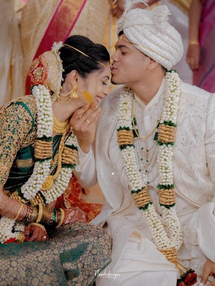An intimate moment of affection between the bride and groom. The groom's gentle kiss on her forehead is a perfect example of the tender love I aim to capture.