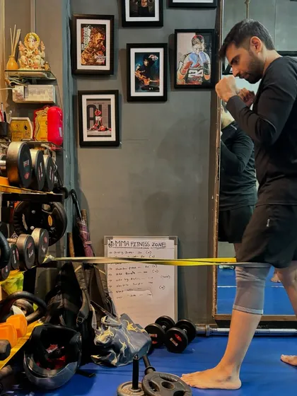 Here, a client is using a resistance band to work on knee resilience and strength. This is a form of corrective exercise I use to help clients overcome pain and prevent future injuries.