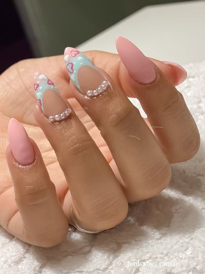Another angle of the stunning matte pink and pearl nail art by my student. The precision in the negative space and pearl placement is a sign of a well-trained artist.