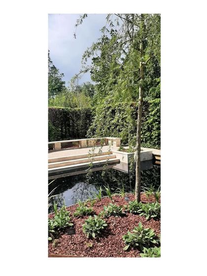 The design of the garden is an expression of four key identities: Blue (water), Green (plants), People (experience), and Biodiversity (habitat). This image captures the interplay of these elements.