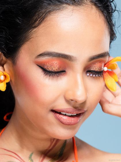 A serene beauty shot with a floral theme, with the model's eyes closed.