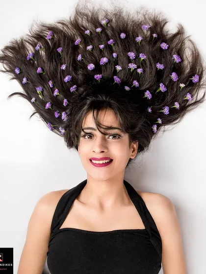Photography can be art. This creative overhead shot uses flowers woven into the hair to create a visually striking and memorable image. It’s an example of how we can collaborate on a unique concept to make your portfolio stand out.