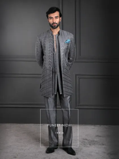 Draped in charcoal sophistication. This layered ensemble features detailed patterns, a shimmering weave, and a timeless mandarin collar, refining tradition into modern luxury.