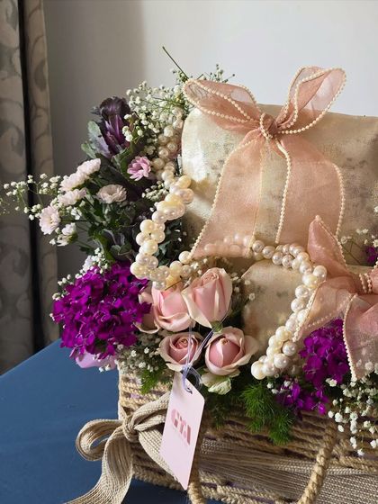 A detail shot focusing on the pearl strings and soft pink roses, key elements that bring a romantic and luxurious feel to my trousseau designs.