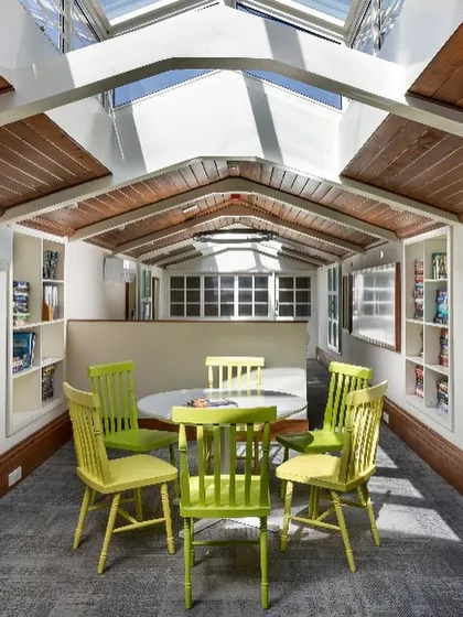 A cozy meeting nook within the attic office, demonstrating how we create diverse functional zones within a single open-plan heritage space.