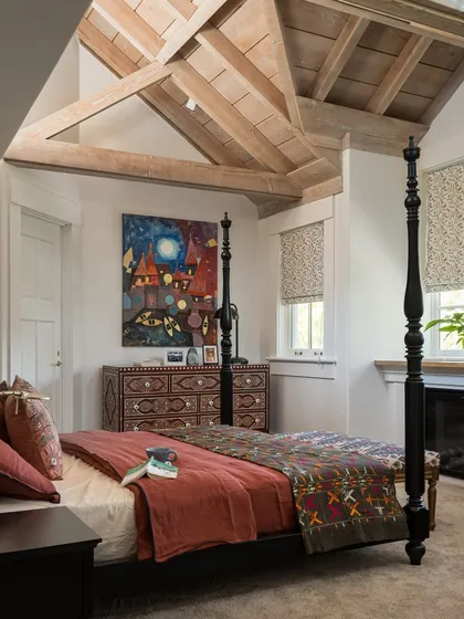 A bedroom should be your personal retreat. For this Saratoga home, I designed a sanctuary with a classic four-poster bed, an intricately designed inlay console, and warm, textural layers. The vaulted wood-beamed ceiling adds a sense of rustic grandeur, making the space feel both cozy and expansive.