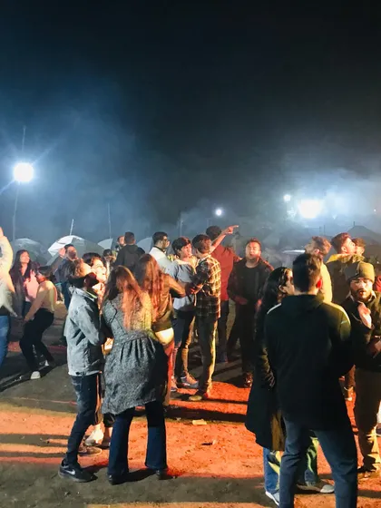 The night comes alive at our camps. Here, guests are gathered around a bonfire, dancing and connecting under the stars. This is the social heart of our lakeside events.