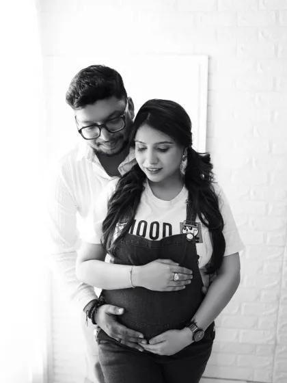 A sweet and intimate black and white couple's portrait. The soft lighting and close embrace create a tender and timeless memory.