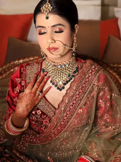 A beautiful shot of a bride in a multi-colored lehenga with a red velvet blouse, perfect for a grand wedding.