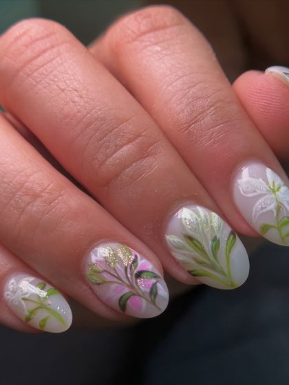 A close-up of my hand-painted lily nail art. I use a special technique to create the soft, translucent look of the petals, with touches of pink and gold for warmth.