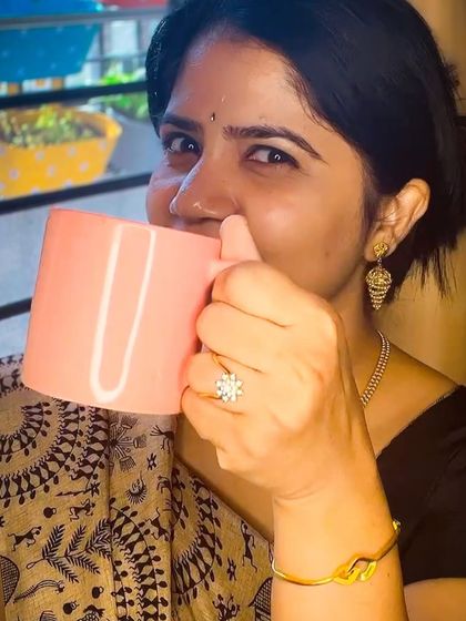 Taking a sip of my favorite tea. It's these little breaks that help me recharge during a busy day as a mom and coach.