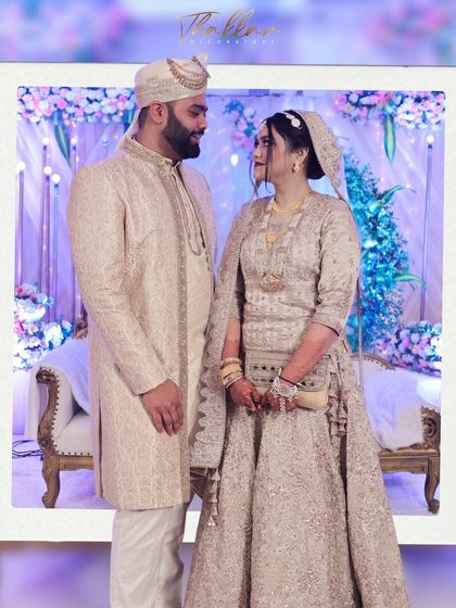 A beautiful portrait of a couple at their reception. The backdrop of soft lavender and pink florals with delicate lighting creates a romantic and elegant setting.