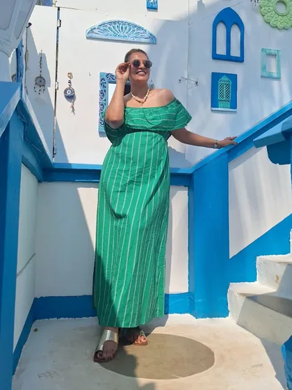Posing on the beautiful blue and white steps at Purple Martini, Goa. The green of my dress pops against the Santorini-inspired decor.