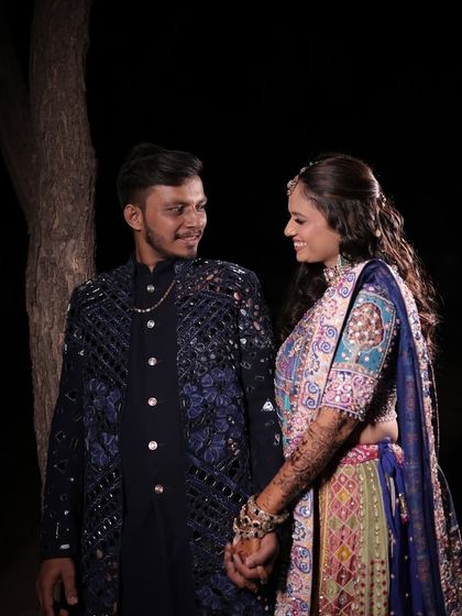 A beautiful couple portrait from a Dandiya celebration. Her makeup is crafted to be radiant and photogenic, with a focus on a dewy finish that looks incredible both in person and in pictures.