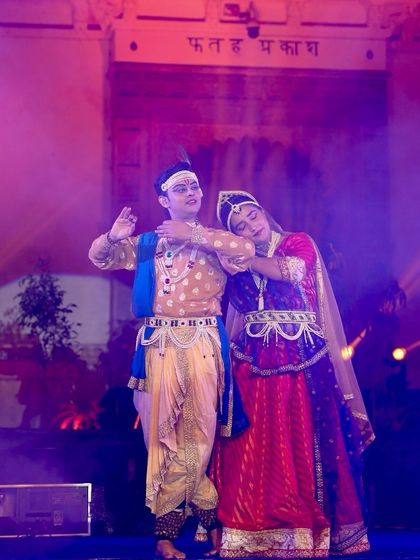 Dancers portraying Radha and Krishna in a tender moment at the Meera Mahotsav. Our abhinaya training focuses on conveying deep emotions with subtlety and authenticity.