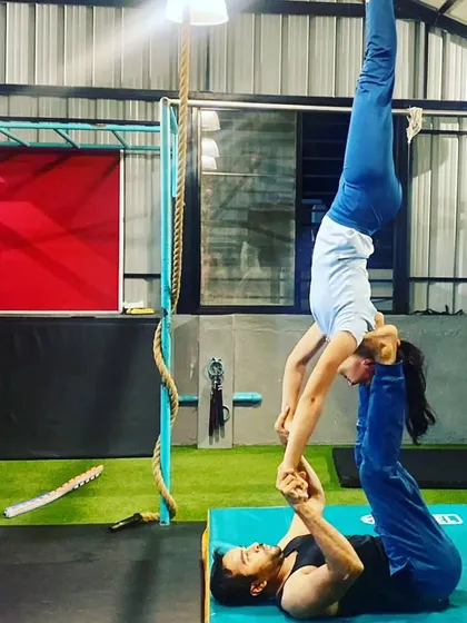 Here we are practicing a hand-to-hand balancing pose. This requires a lot of stability from me as the base and precise control from my partner, the flyer.