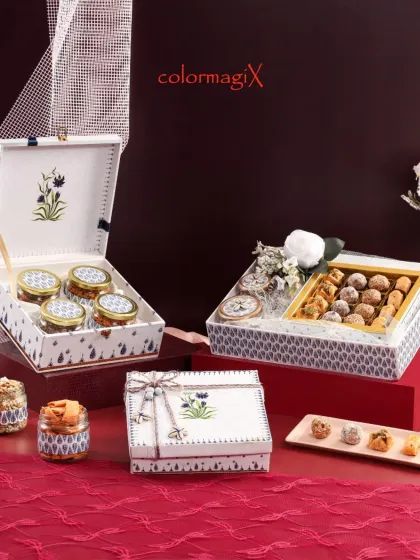 A detailed view of our white and blue floral collection, highlighting the delicate artwork and coordinated packaging. These hampers are perfect for those who appreciate understated luxury.