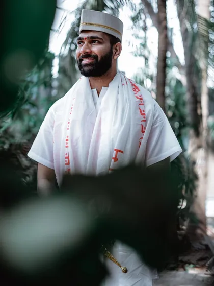 A candid portrait of the groom looking away with a smile during his Haldi ceremony.