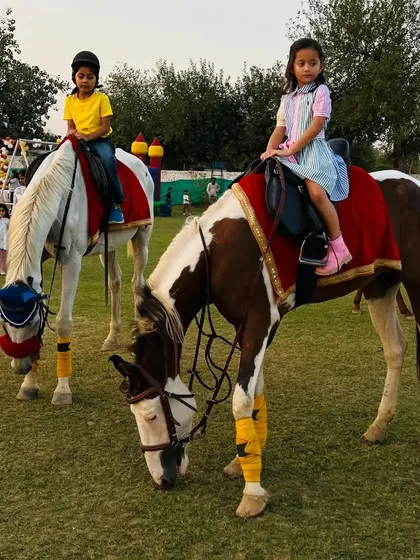 Two young friends enjoy a ride together during a birthday party at the club. Our horses are gentle and well-trained for events with children.