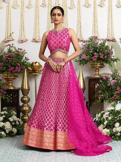 The combination of a fully patterned Bandhani lehenga and a matching embellished blouse creates a look of cohesive elegance, perfect for a bride or her closest family.