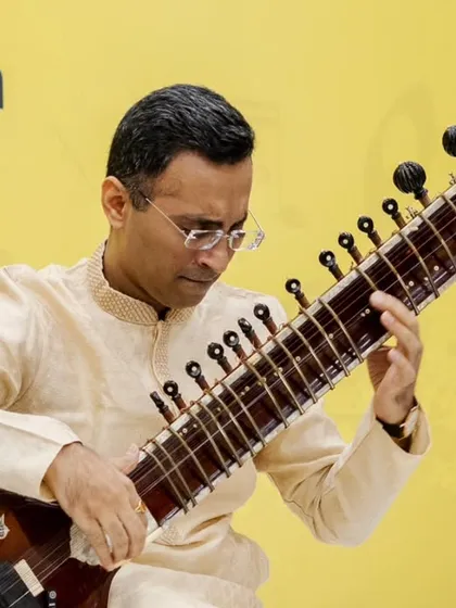 A detailed shot of my hands and the sitar's fretboard during the lecture demonstration.