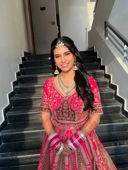 The full look, showcasing her beautiful pink Manyavar lehenga. The makeup is designed to complement the outfit without competing with it.