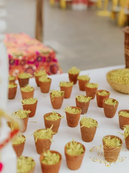 A close-up of snacks served in traditional terracotta kullads, presented on the decorative cart. We believe in paying attention to every detail, including food presentation.