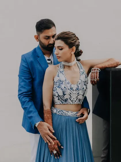 A stylish portrait of a couple, showcasing their modern and coordinated outfits for their pre-wedding party.